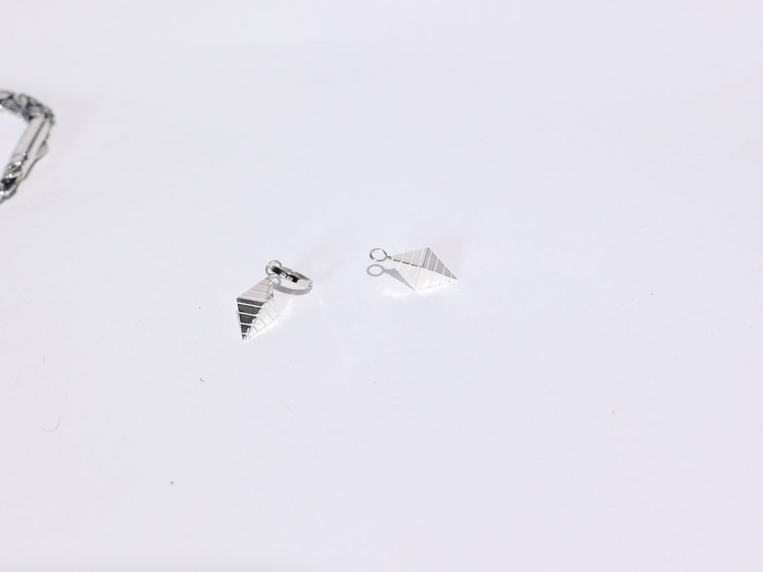 Three silver rings on a light gray background