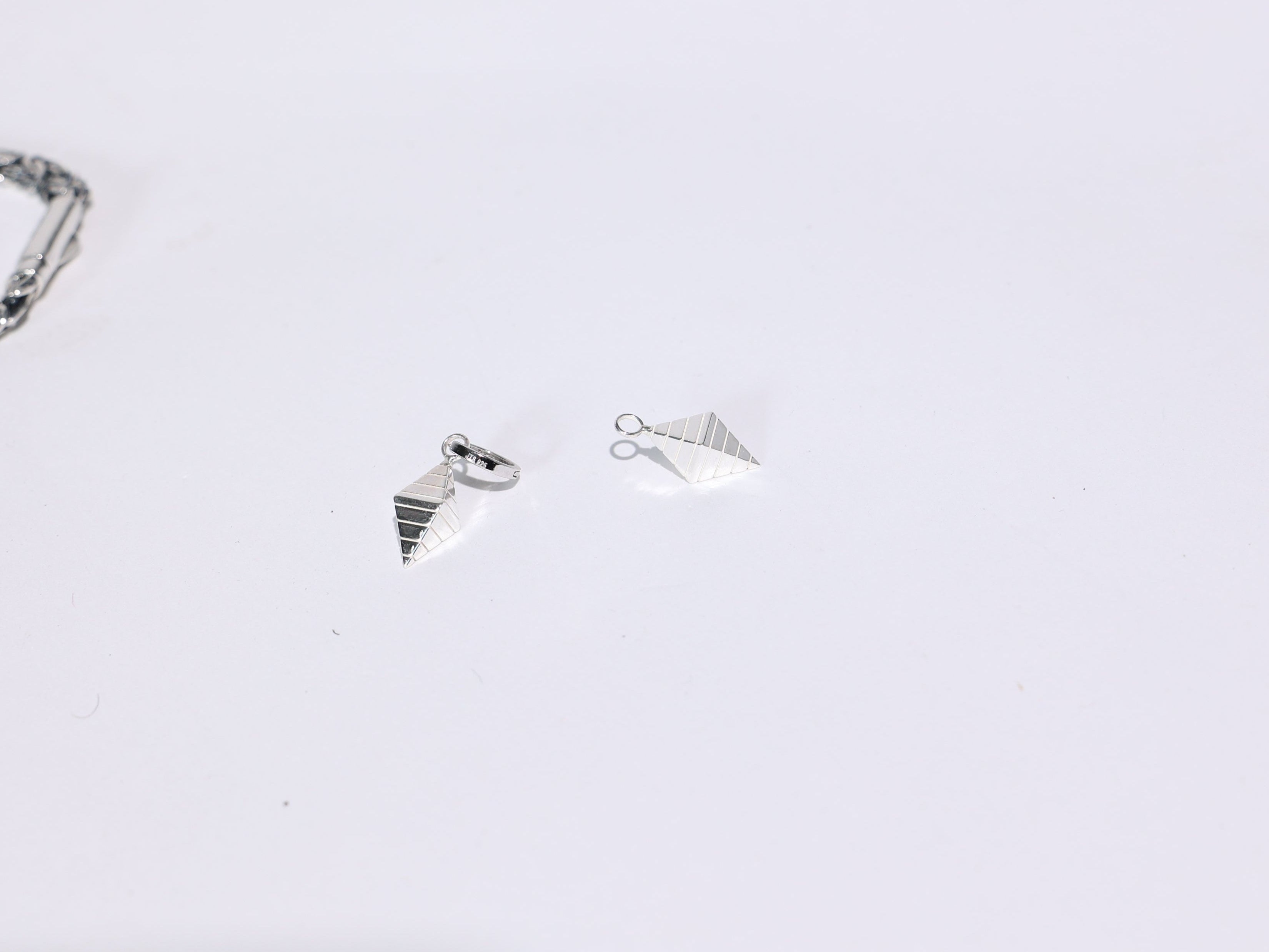 Three silver rings on a light gray background