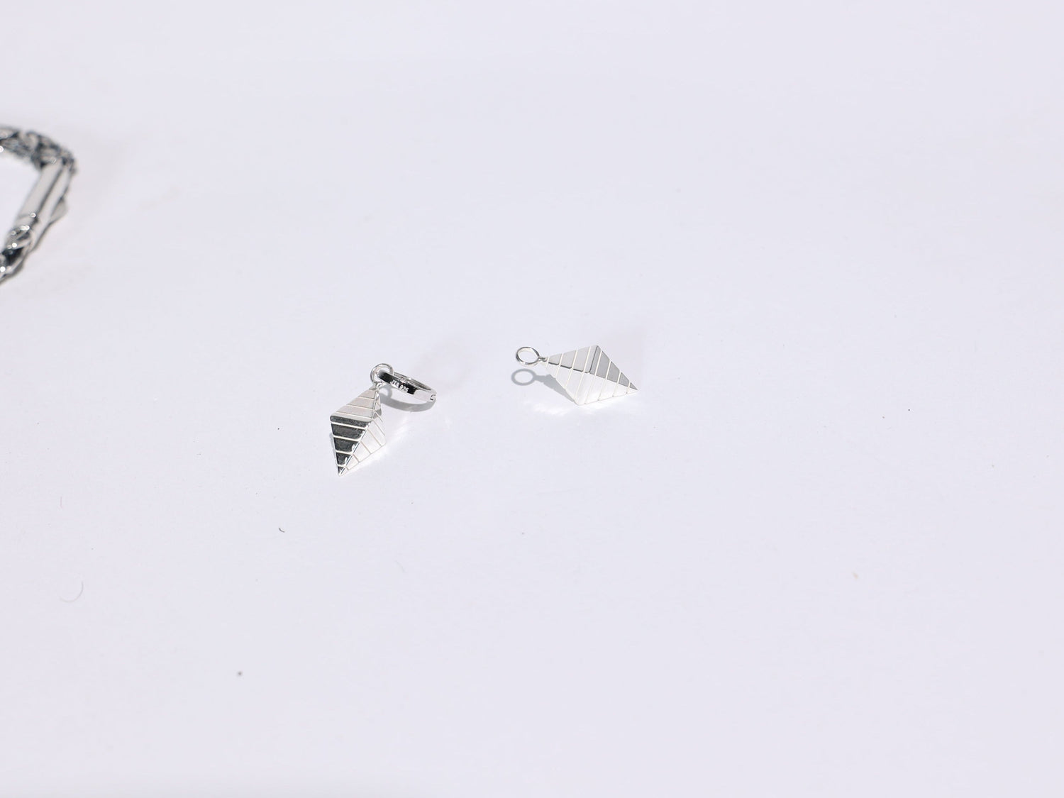 Three silver rings on a light gray background