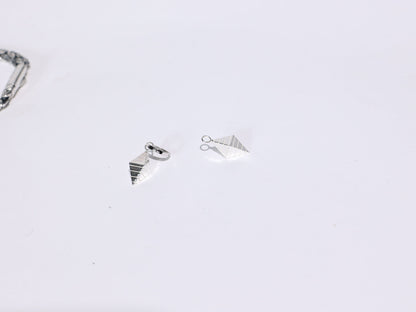 Three silver rings on a light gray background