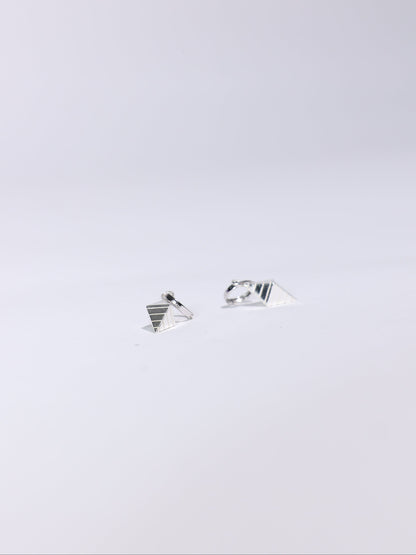 Pair of silver earrings on a light gray background
