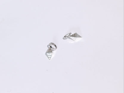 Pair of silver geometric earrings on a light gray background